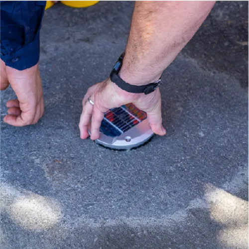 Person installing a traffic counter sensor