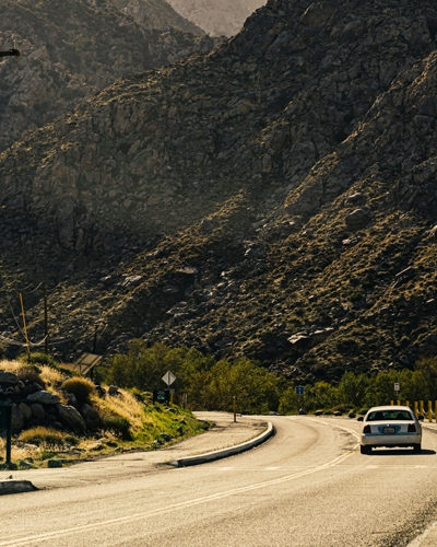 Photo by Ricky Esquivel: https://www.pexels.com/photo/a-car-on-the-road-beside-rocky-mountains-3881273/